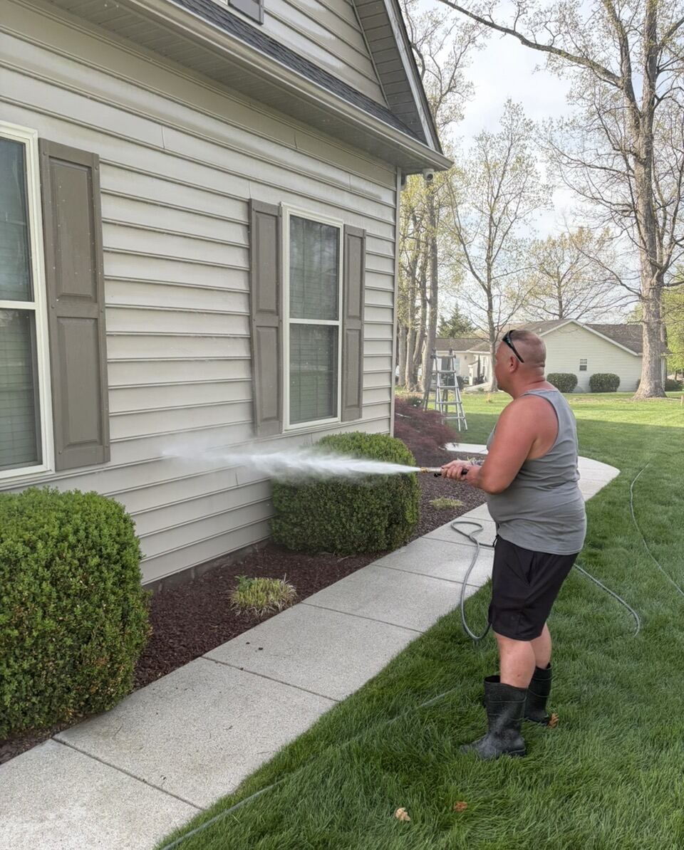 OC Blast technician soft washing a residential exterior